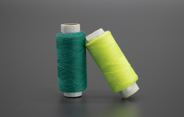 Sewing thread and bobbin isolated on black background, spool, yarn on tube, cotton, wool