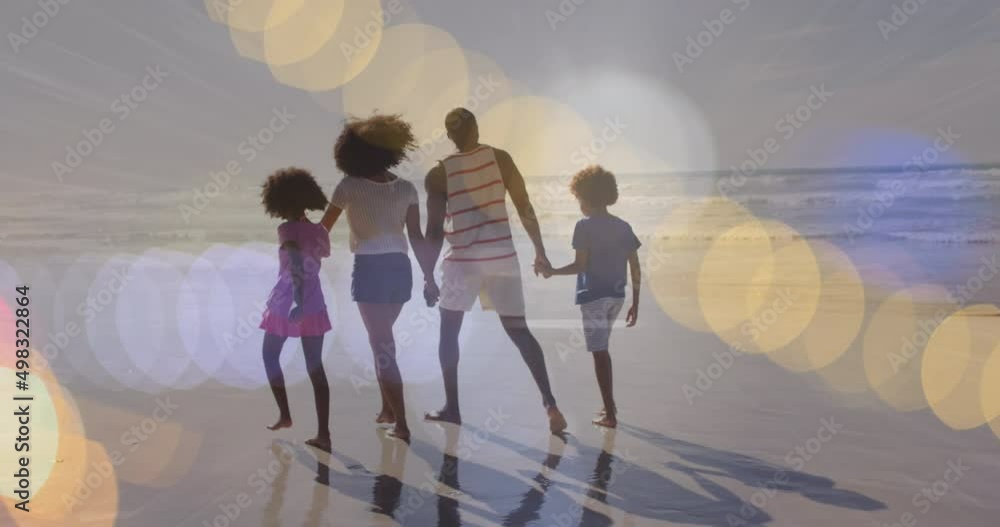 Canvas Prints Animation of light spots over african american family walking together