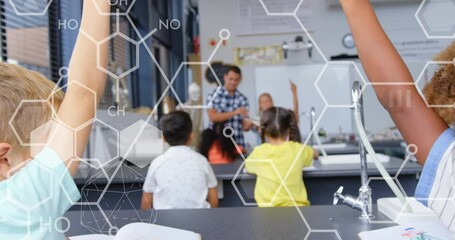 Animation of chemical icons over diverse schoolchildren raising hands in classroom