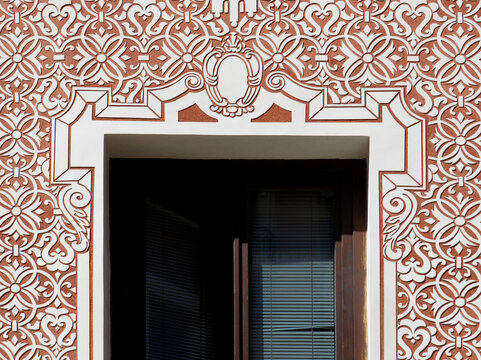 Detail of facade with sgraffito geometric decoration in the historic city center of Madrid. Spain. 