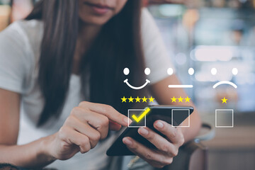 Customer service satisfaction survey concept,Woman using smartphone showing satisfaction through screen application By giving most satisfaction rating and 5 stars
