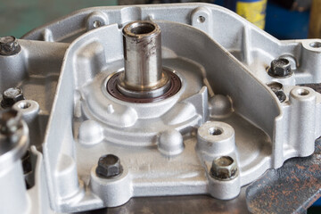 The front oil seal of the crankshaft of an automobile engine mounted on a partially disassembled engine