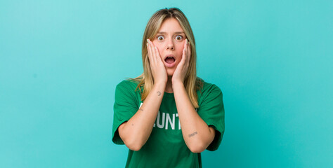 pretty blonde woman feeling shocked and scared. volunteer concept