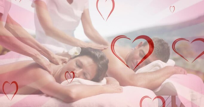 Animation of hearts falling over caucasian couple in spa during massage