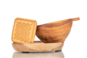 One sugar cookie with a wooden saucer and cup, close-up, isolated on a white background.