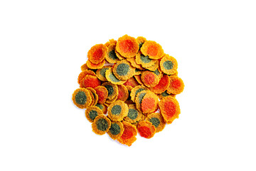 Dry handful, bunchmulti-colored compound fish feed flakes on White background. Top view