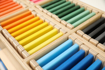 Wooden box with color tablets, closeup. Montessori toy