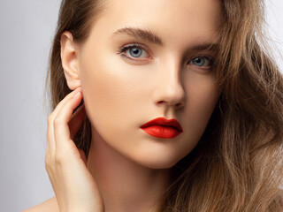Beauty Face. Beautiful Woman With Sexy Full Red Lips. Closeup Portrait Of Girl With Healthy Smooth Facial Skin Applying Lip Balm On Lip. High Resolution. cosmetology, make up, injections, spa