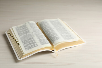 Open Bible on white wooden table. Christian religious book
