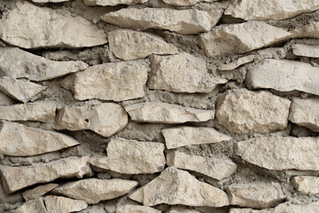 Stone wall handmade. Gray stone background. Textures of stone and cement.
