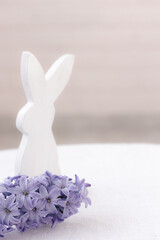 Beautiful blue blooming hyacinth flowers, white rabbit on white background. Easter mock up
