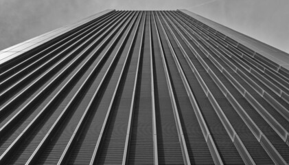 A black and white image of a tall futuristic london building