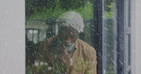 Animation of white spots over sad senior african american man