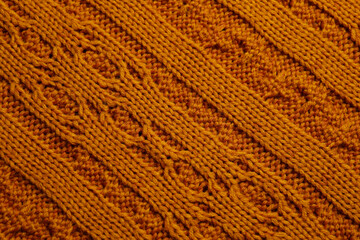 Beautiful orange knitted fabric as background, top view