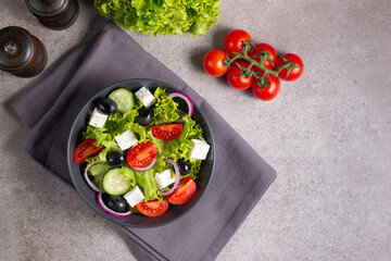 Greek salad with fresh tomatoes, cucumber, olives, feta cheese and red onion. Healthy and diet food concept.