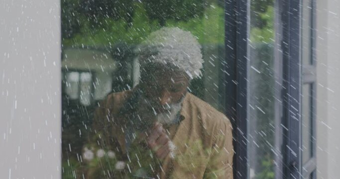 Animation of white spots over sad senior african american man - Powered by Adobe