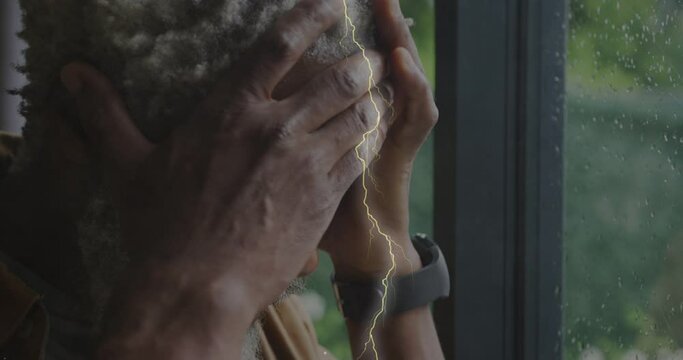Animation of lightning over sad senior african american man - Powered by Adobe