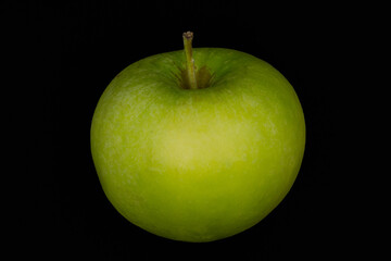 Fresh green apple and sliced isolated on black background.