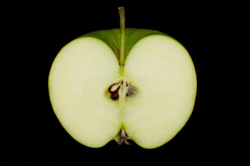 Fresh green apple and sliced isolated on black background.