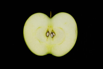 Fresh green apple and sliced isolated on black background.