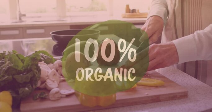 Animation of 100 percentage organic text over caucasian woman cooking