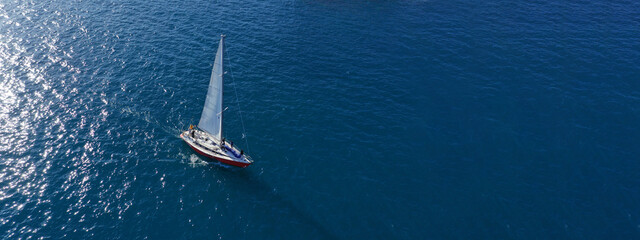 Aerial drone ultra wide panoramic photo with copy space of beautiful sail boat with white sails...