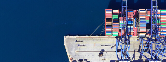Aerial drone ultra wide top down panoramic photo with copy space of container tanker anchored in...
