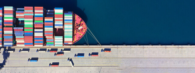 Aerial drone ultra wide top down panoramic photo with copy space of container tanker anchored in...