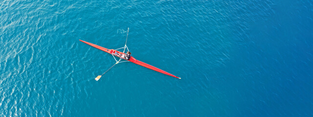 Aerial drone ultra wide top down panoramic photo with copy space of sport canoe operated by young woman in deep blue calm sea waters © aerial-drone