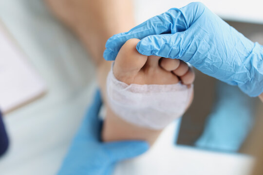 Doctor conducts medical examination of foot with patch