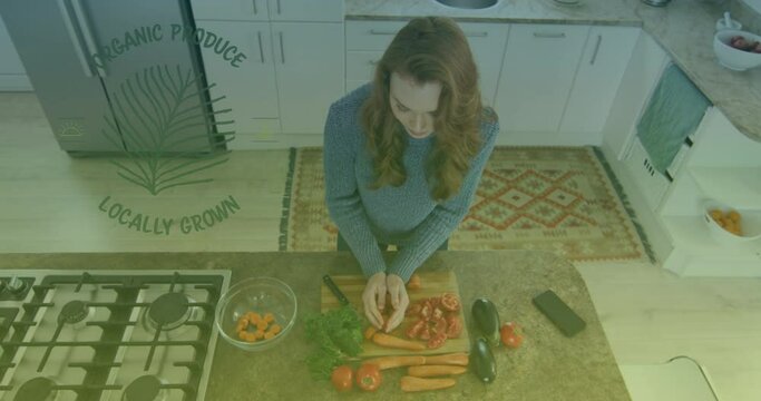 Animation of organic produce text over caucasian woman cutting vegetables