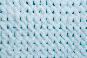 Soft light blue knitted fabric as background, top view