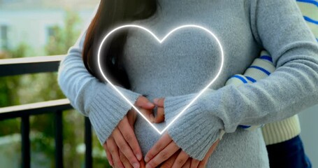 Animation of neon heart over happy diverse couple embracing