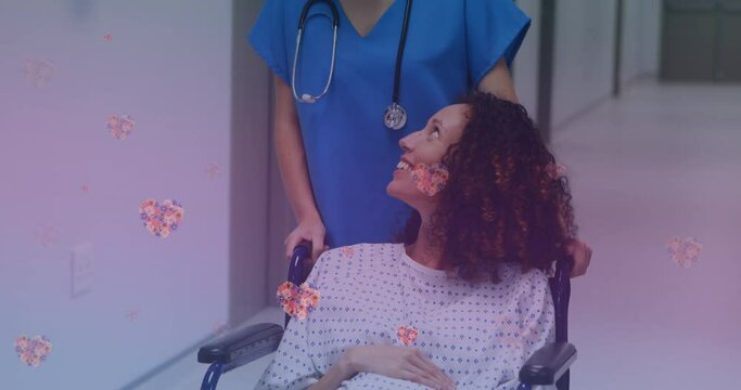 Animation of heart icons over happy biracial pregnant woman talking with nurse