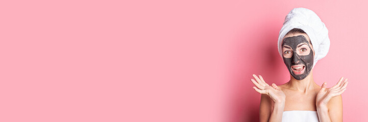 cosmetic face mask, spa procedures. Girl with mask on her face on a pink background. Banner.