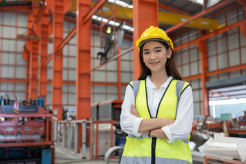 Female Industrial Worker Standing with Arm Crossed in the Factory