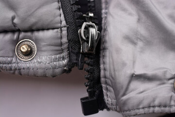 Close-up of a broken zipper on a jacket.