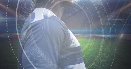Animation of scope scanning over african american male rugby player with ball at stadium - Powered by Adobe