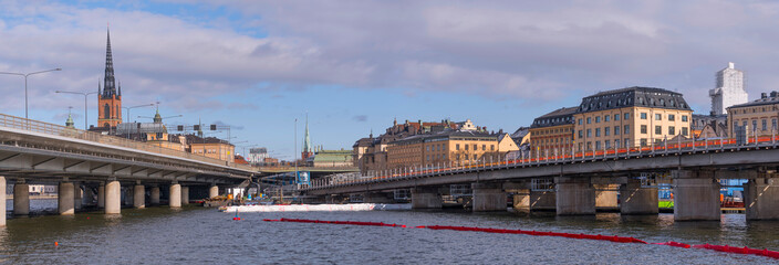Bridges for subway trams and cars at the sluice area at the old town Gamla Stan a snowy spring day in Stockholm