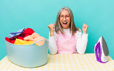 senior  gray hair woman shouting aggressively with an angry expression iron and clothes concept