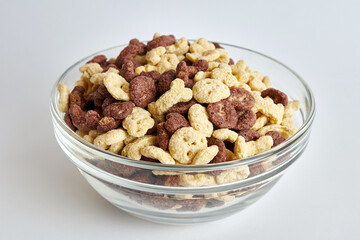 Granola in a transparent bowl on a white background. Healthy food. Baby food.