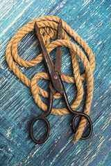 vintage scissors and jute rope on a blue old table.