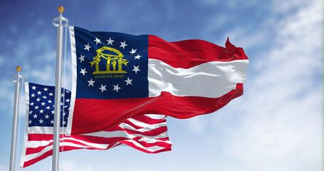 The Georgia state flag waving along with the national flag of the United States of America