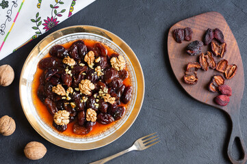Obraz na płótnie Canvas Homemade dried plum dessert with walnuts, traditional dessert with syrup