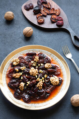 Homemade dried plum dessert with walnuts, traditional dessert with syrup