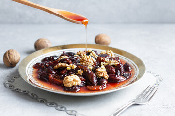 Homemade dried plum dessert with walnuts, traditional dessert with syrup
