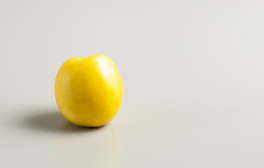 Ripe yellow apple on gray background, top view, space for text, stock photo