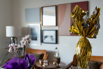 Easter egg with a flower. Multicolored Easter eggs wrapped in foil.