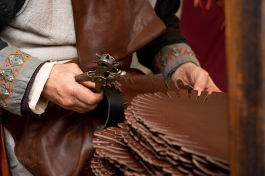 leather craftsman working in medieval market stall