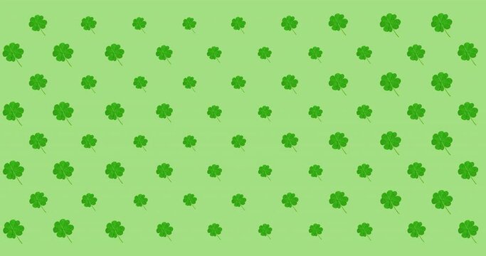 Animation of rows of pulsating clover leaves on green background